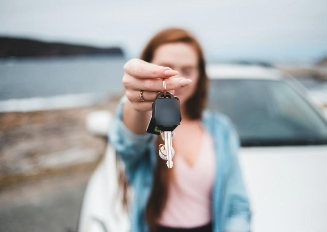 Seller holding out her car keys
